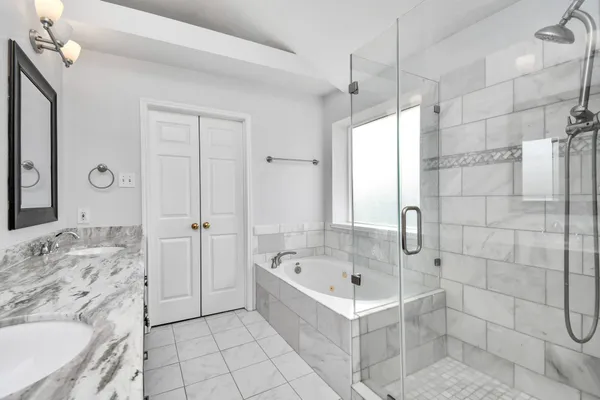 a bathroom with a bathtub a sink a toilet and shower