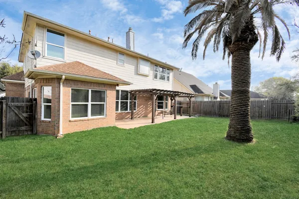 a front view of a house with a garden and yard
