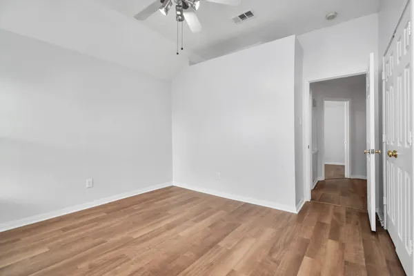 a view of a room with wooden floor