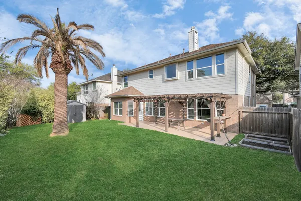 a view of a house with a yard and sitting area