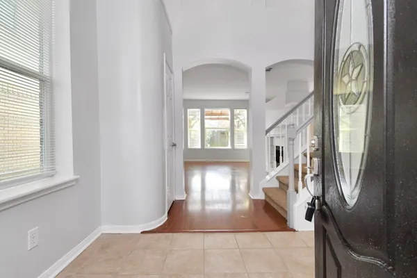 a view of entryway and hall with wooden floor