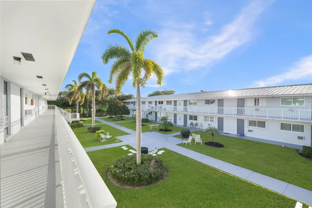 a view of house with yard in front of it