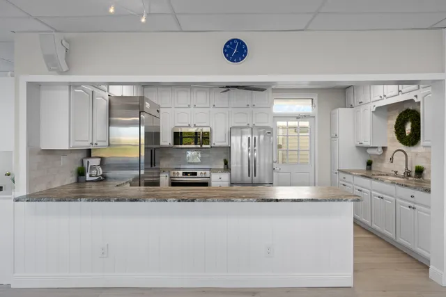 a kitchen with refrigerator and windows