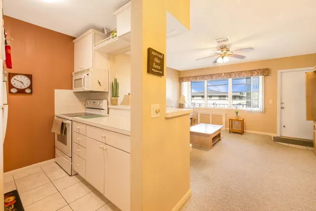 a kitchen with a sink a refrigerator and a stove