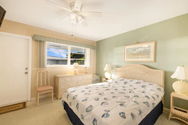 a spacious bedroom with a bed and a dresser