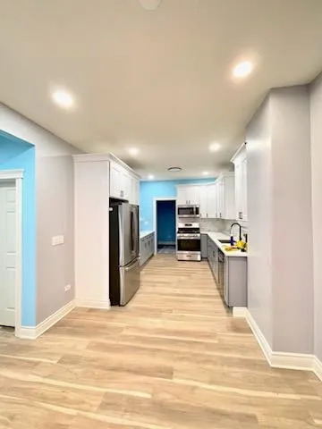 a view of kitchen and kitchen with a sink