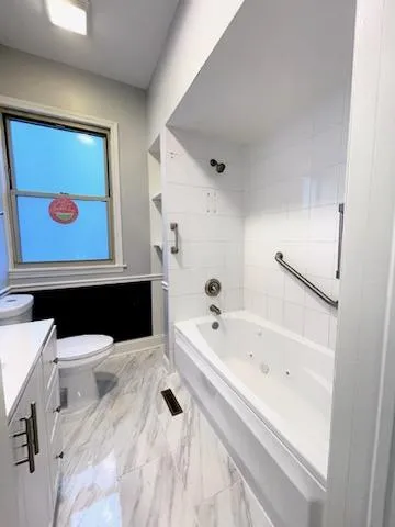 a bathroom with a sink a toilet and mirror