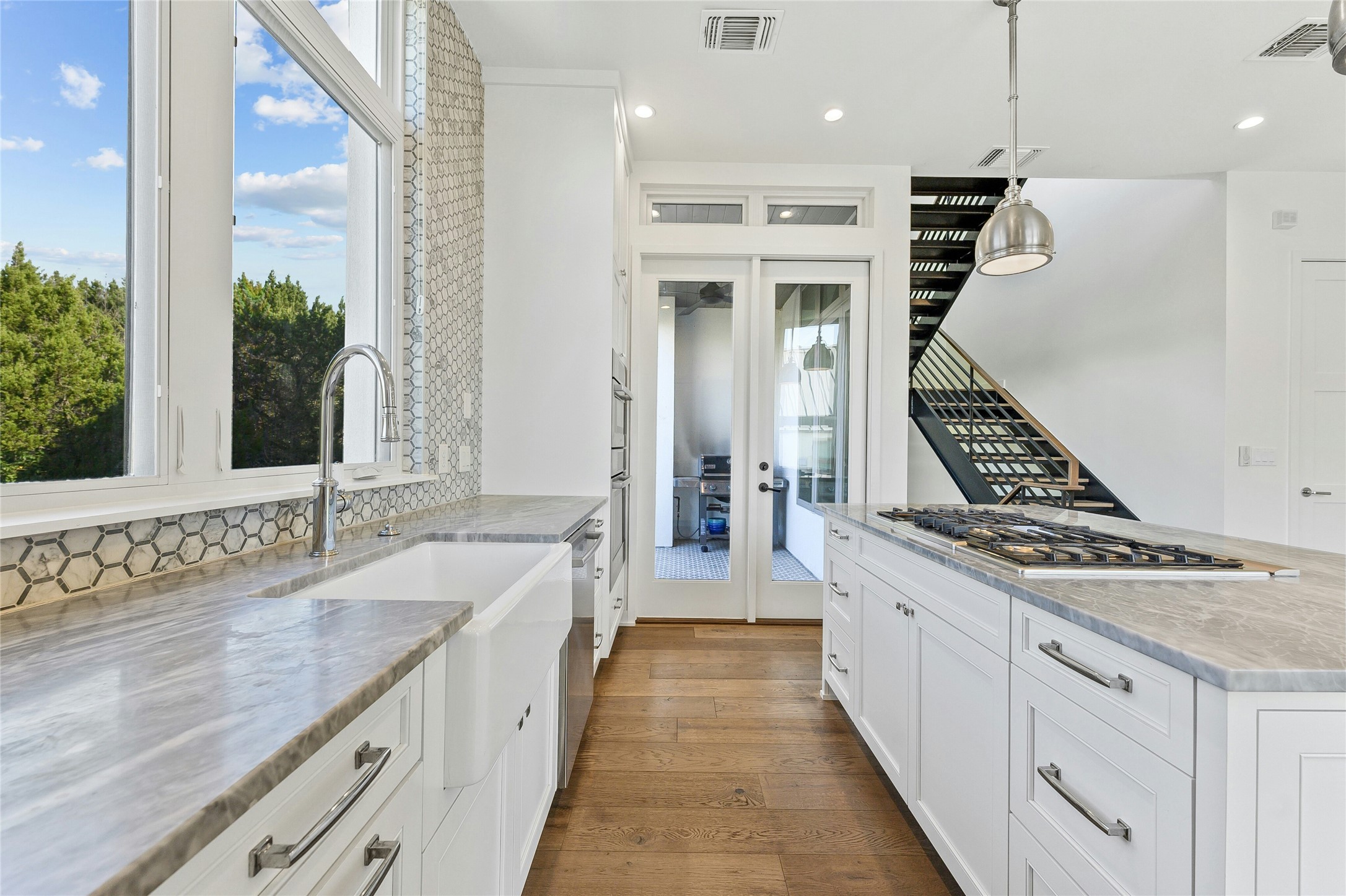 2518 Sutherland Street Austin, TX 78746 - Photo 11 of 30 A sleek, contemporary kitchen with premium finishes and an inviting open concept to the living areas.