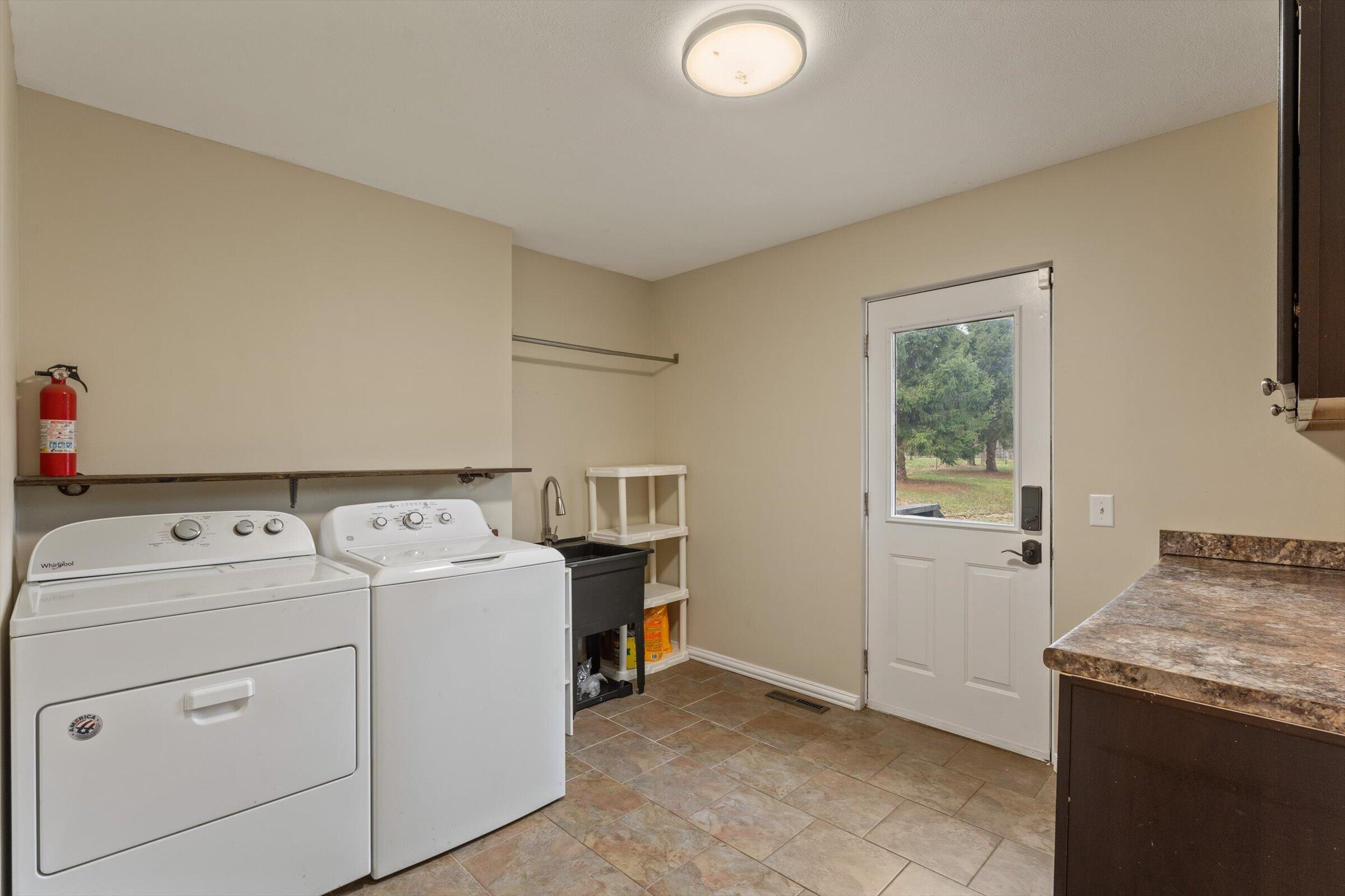 7692 North Emery Road Rolling Prairie, IN 46371 - Photo 19 of 69 a utility room with dryer and washer