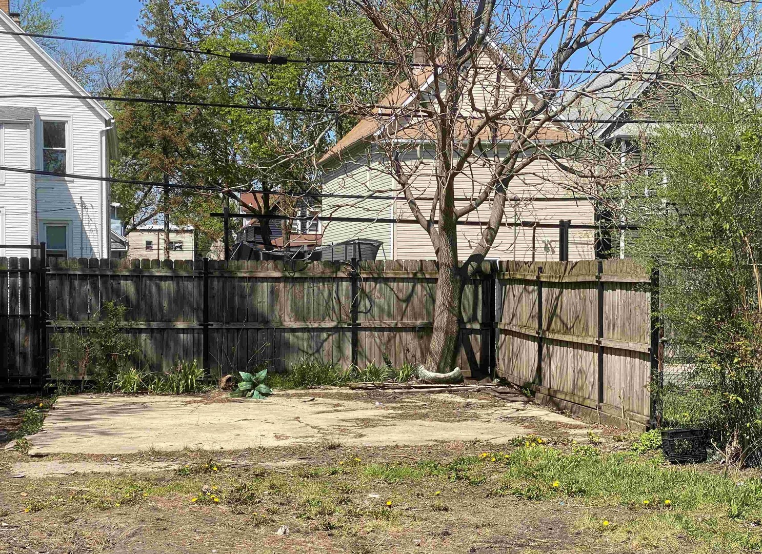 4922 West Ferdinand Street Chicago, IL 60644 - Photo 5 of 9 a backyard of a house with lots of green space and chair