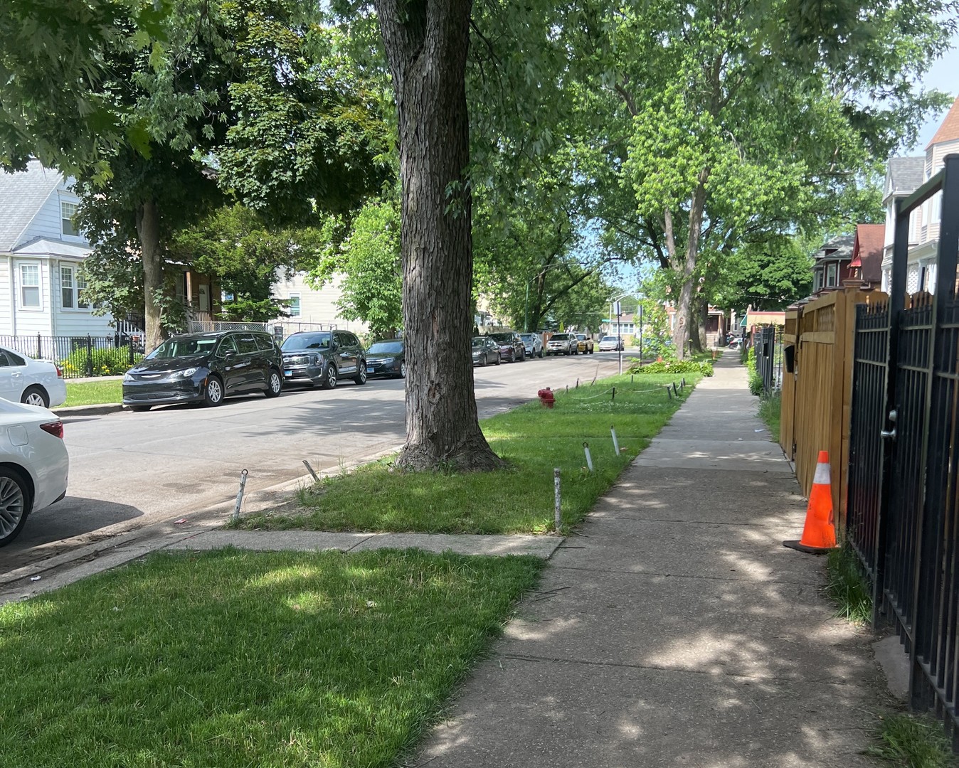 4922 West Ferdinand Street Chicago, IL 60644 - Photo 9 of 9 a view of a street with a bench and trees