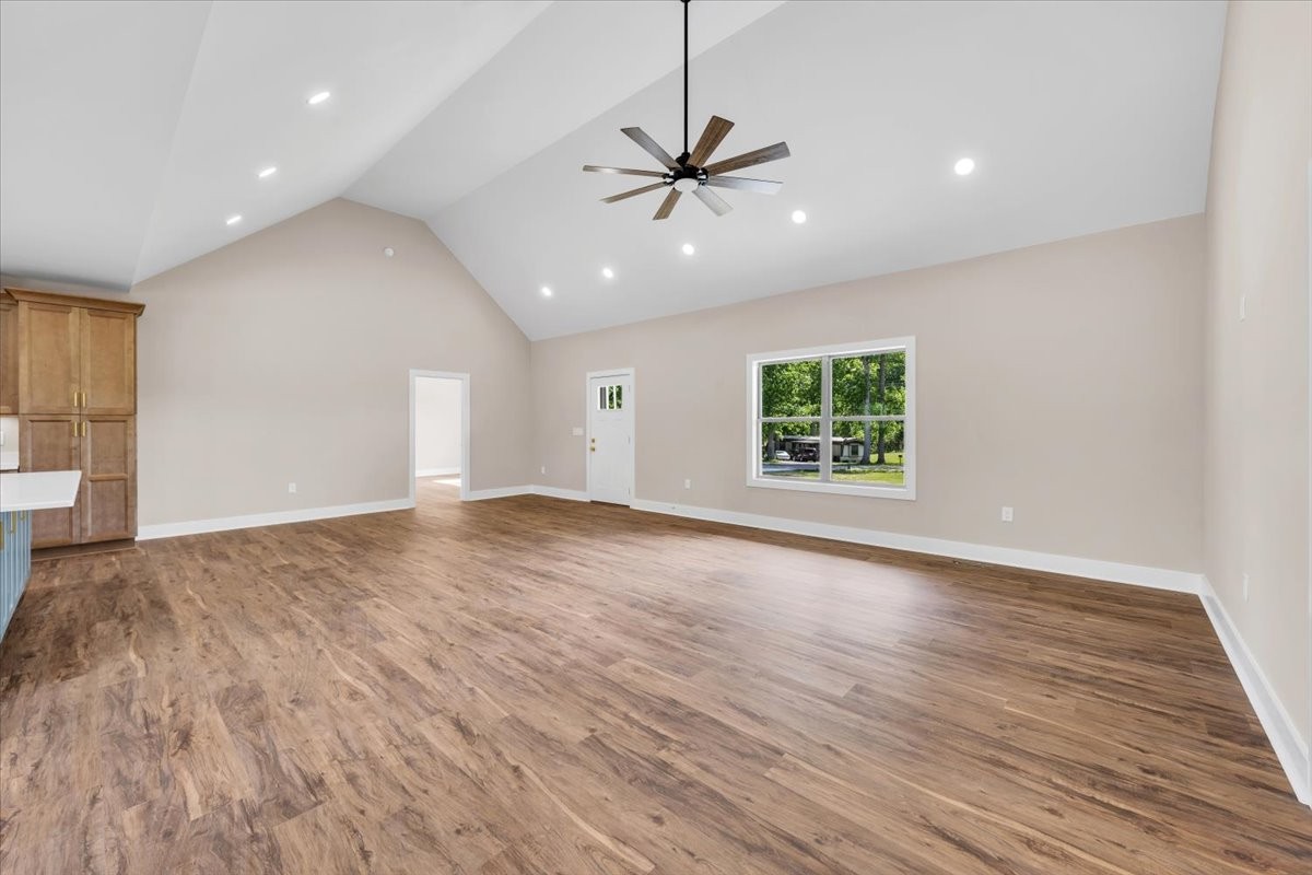 139 Brinkley Road Wartrace, TN 37183 - Photo 5 of 41 an empty room with wooden floor ceiling fan and windows