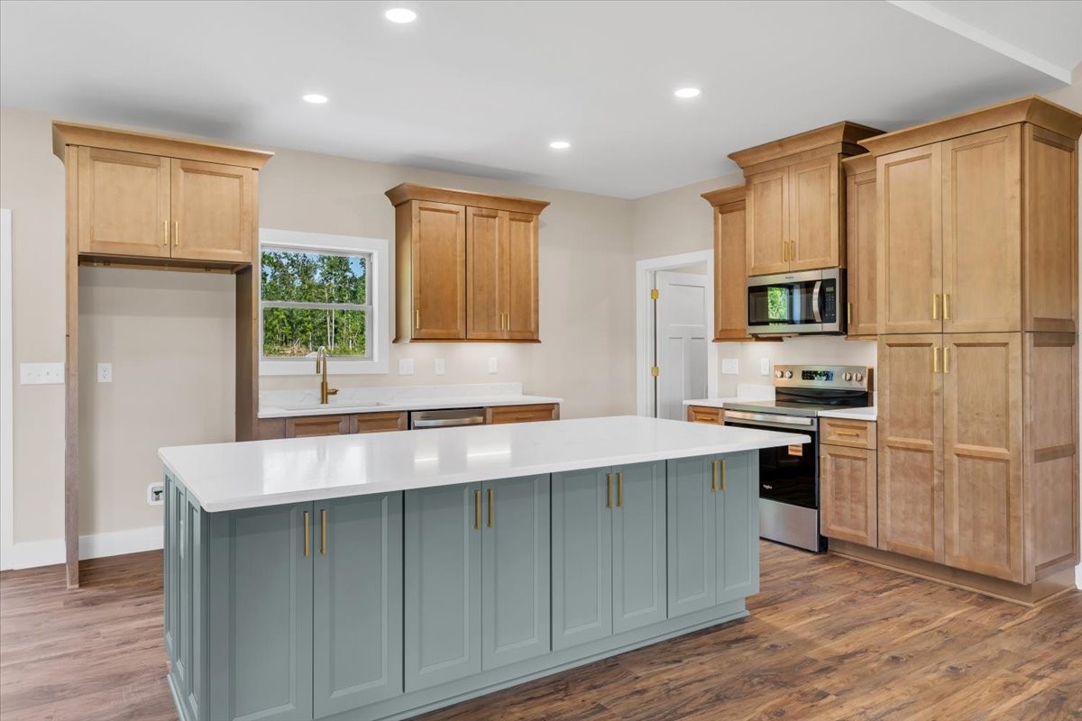 139 Brinkley Road Wartrace, TN 37183 - Photo 9 of 41 a kitchen with kitchen island granite countertop a stove a sink and a refrigerator with wooden floor