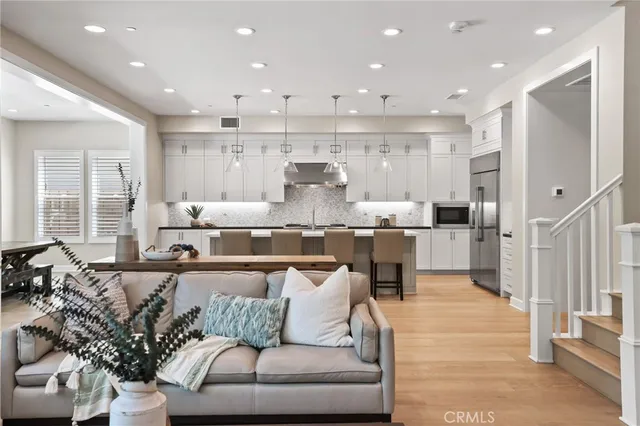 a living room with furniture and kitchen view
