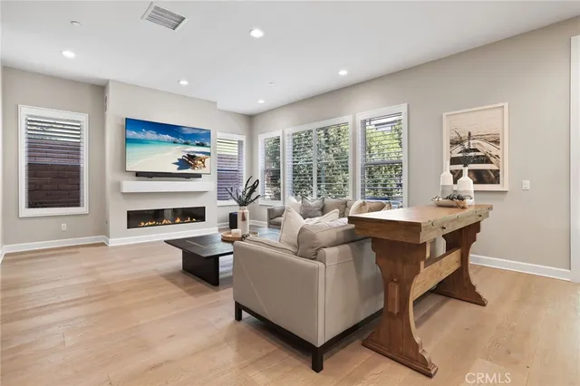 a living room with fireplace furniture and a large window