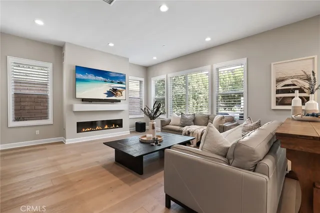 a living room with fireplace furniture and a flat screen tv
