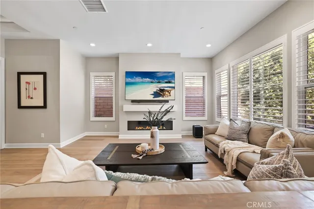 a living room with furniture large window and a table