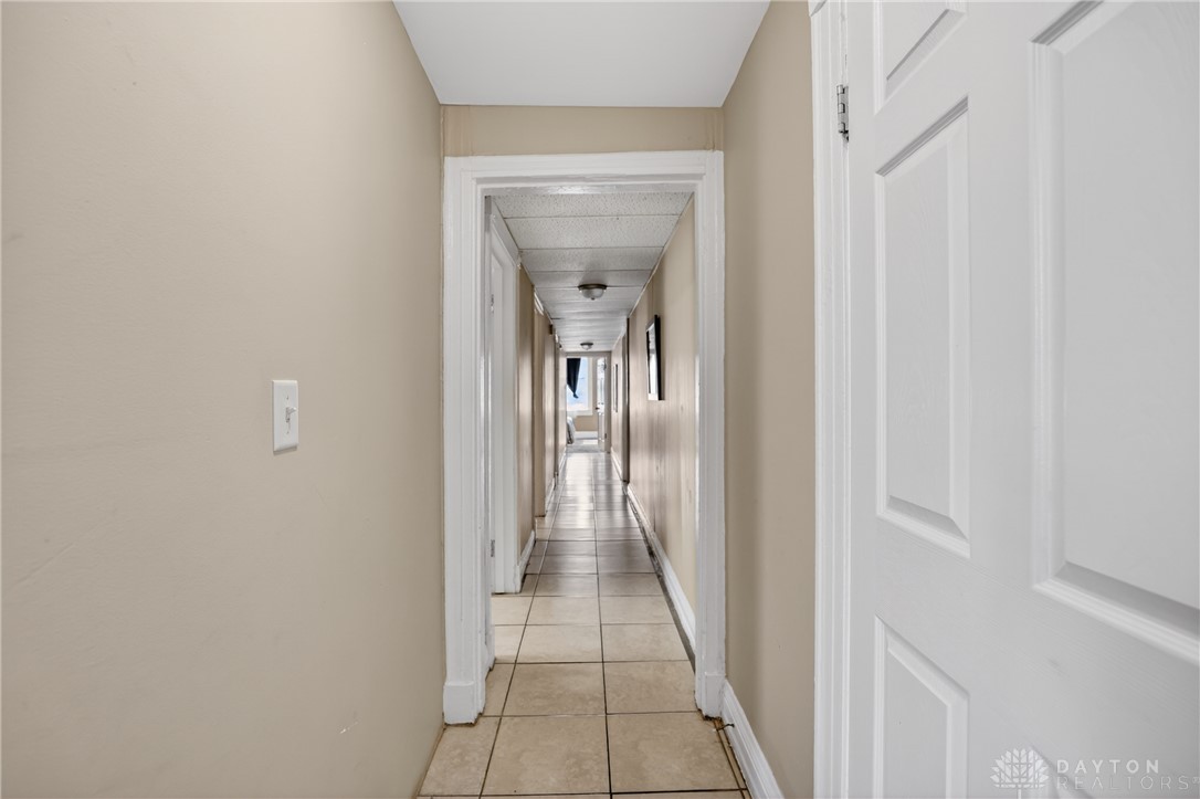 7045-7049 Montgomery Road Cincinnati, OH 45236 - Photo 37 of 68 This interior hallway features neutral tones, tile flooring, and leads to other rooms.
