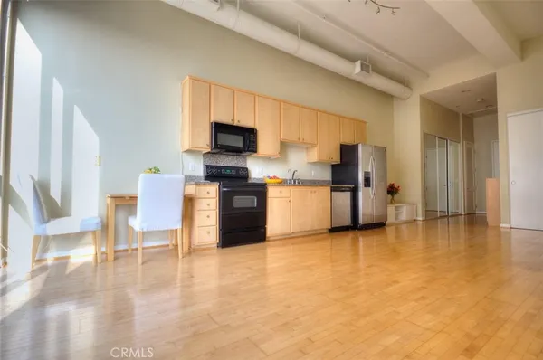 a view of kitchen with furniture microwave and refrigerator