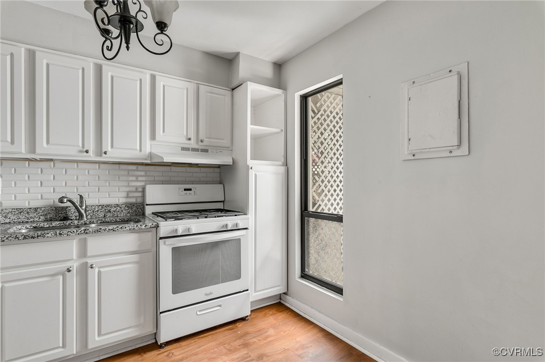 10174 Iron Mill Road North Chesterfield, VA 23235 - Photo 4 of 19 a kitchen with granite countertop white cabinets and white appliances