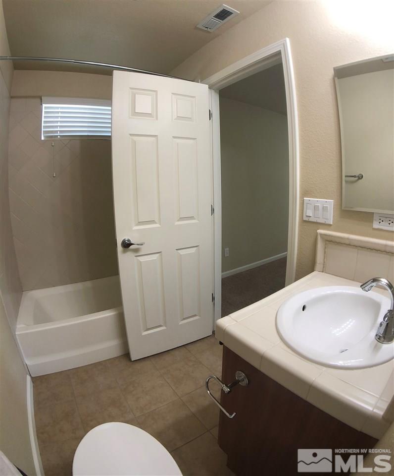 230 Gramercy Lane Reno, NV 89509 - Photo 18 of 20 a bathroom with a sink a toilet and shower