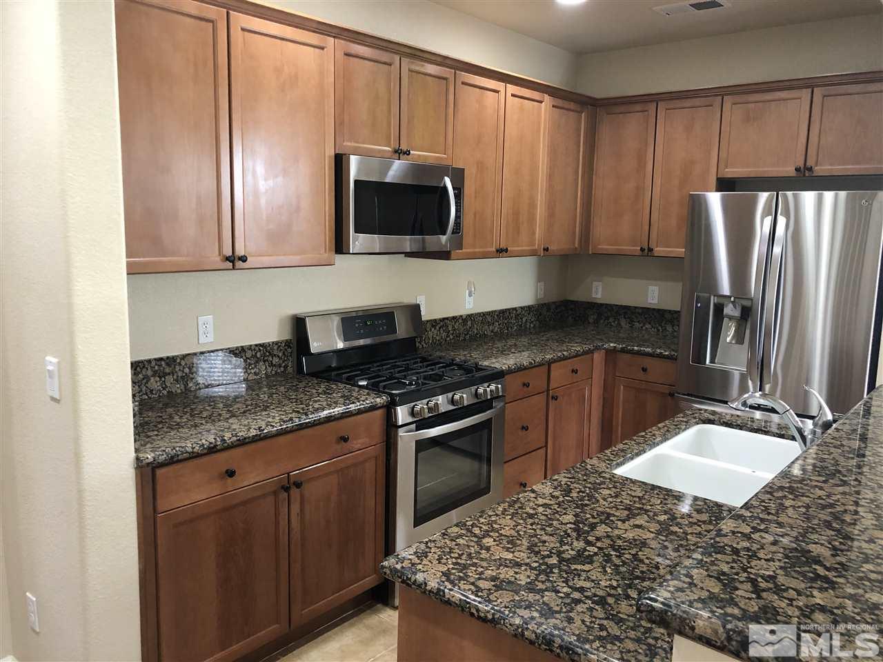 230 Gramercy Lane Reno, NV 89509 - Photo 4 of 20 a kitchen with stainless steel appliances granite countertop a sink stove and refrigerator