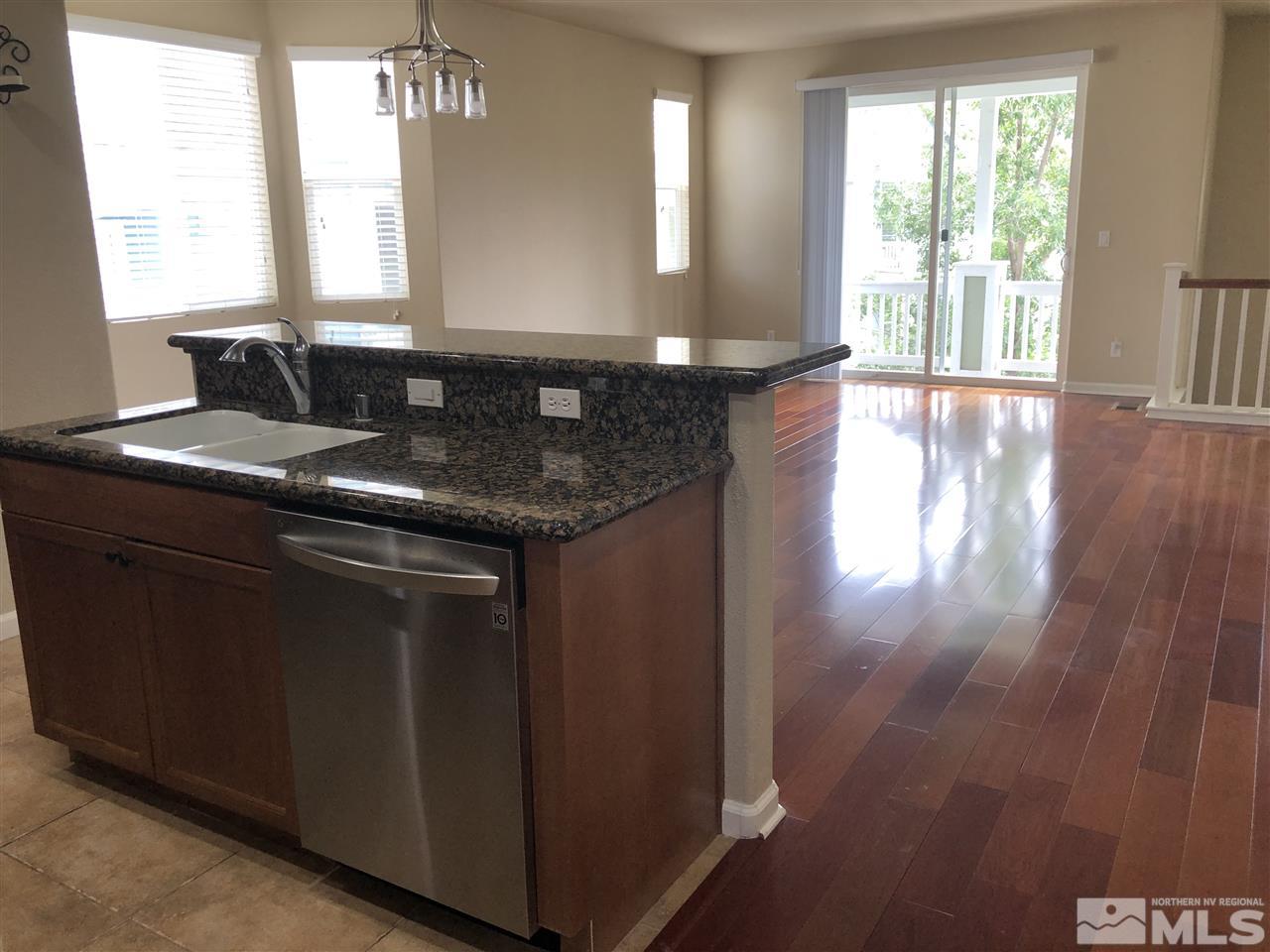230 Gramercy Lane Reno, NV 89509 - Photo 5 of 20 a kitchen with a sink window and cabinets