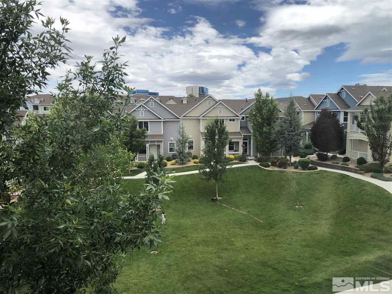 230 Gramercy Lane Reno, NV 89509 - Photo 7 of 20 a view of a lake with a house in the background