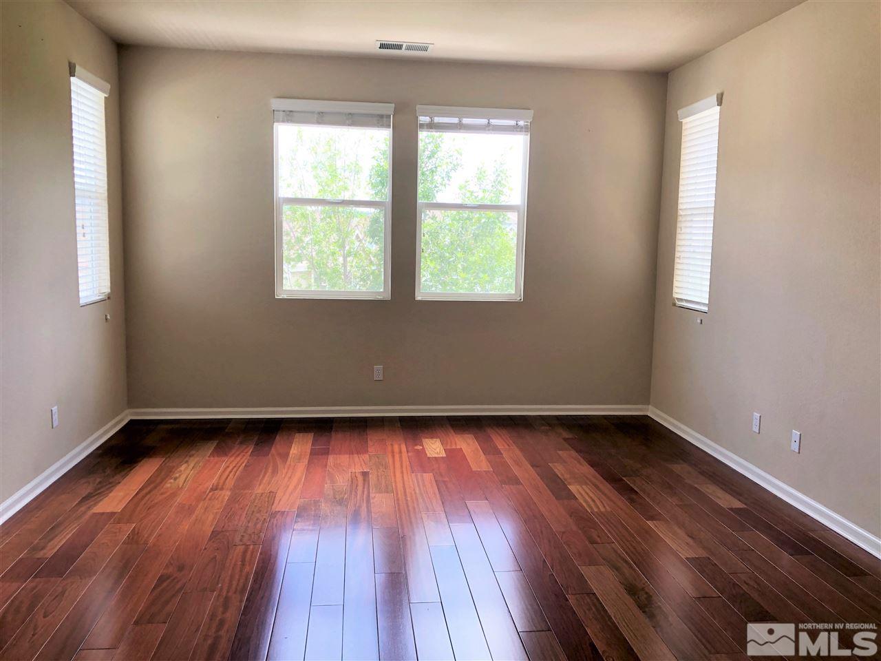 230 Gramercy Lane Reno, NV 89509 - Photo 9 of 20 a view of an empty room with wooden floor and a window