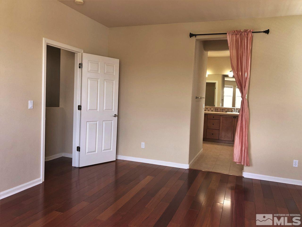 230 Gramercy Lane Reno, NV 89509 - Photo 10 of 20 an empty room with wooden floor and windows