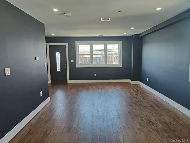 a white toilet sitting next to a white sink and vanity