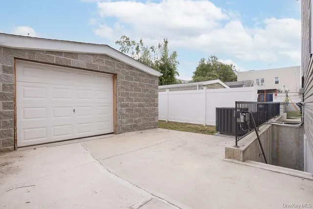 a view of a pathway with a wooden fence
