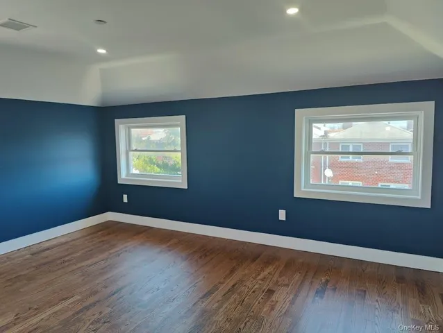 a view of kitchen with wooden floor and electronic appliances