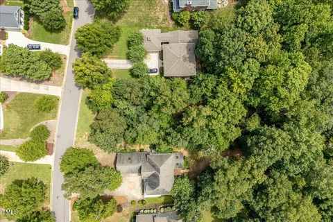 an aerial view of a house with a yard and plants