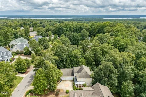 a view of a yard with table and chairs plants