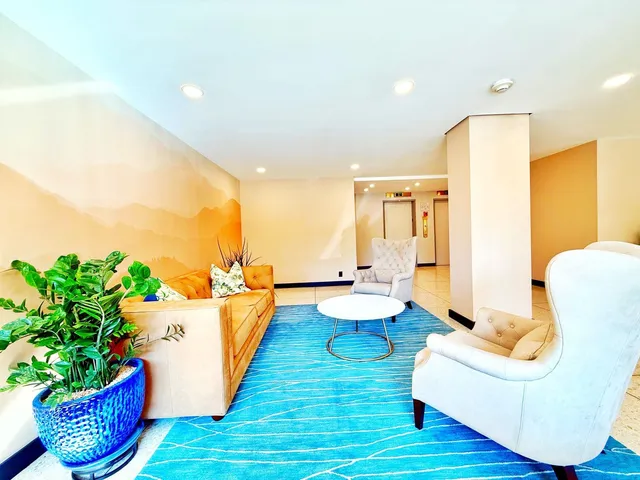 a living room with furniture and a potted plant