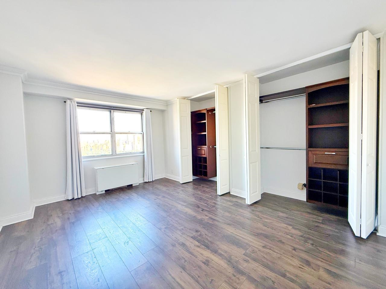 6600 Boulevard East, Unit 22B West New York, NJ 07093 - Photo 5 of 20 wooden floor in an empty room with a window