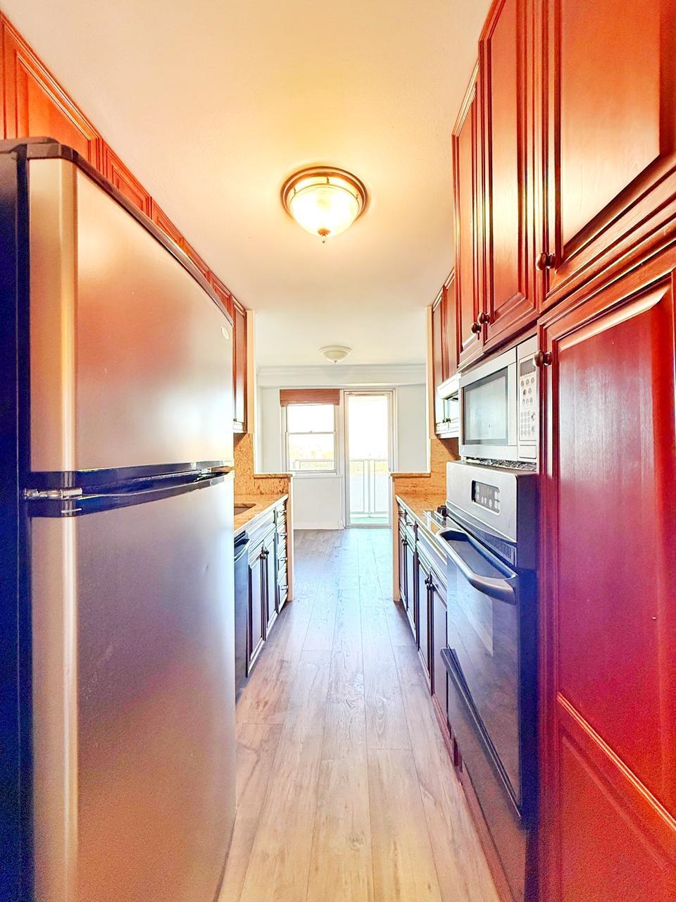 6600 Boulevard East, Unit 22B West New York, NJ 07093 - Photo 6 of 20 a kitchen with stainless steel appliances granite countertop a refrigerator a stove and a wooden floor