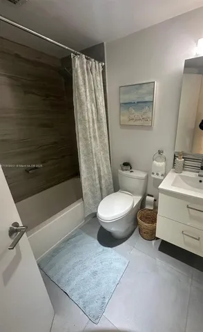 a bathroom with a toilet a sink and bathtub