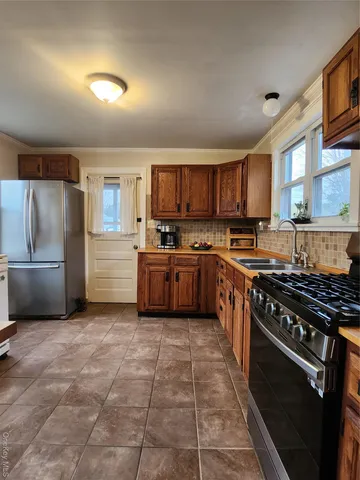 a kitchen with a stove a sink and a refrigerator