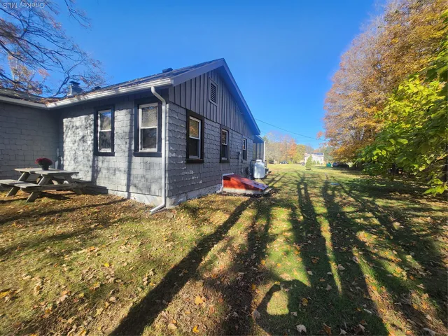 a front view of house along with trees