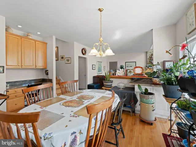 a room with stainless steel appliances kitchen island granite countertop furniture and a dining table