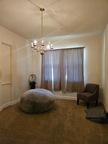 a spacious bedroom with a balcony a bed and a fireplace