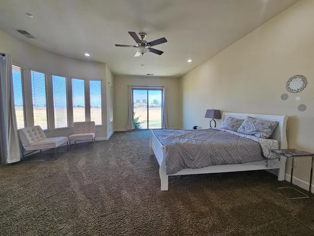 a bathroom with a tub double vanity sink and a mirror