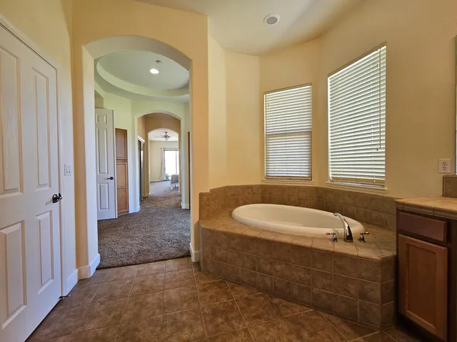 a kitchen with a table chairs sink and cabinets