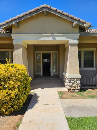 a view of a house with potted plants