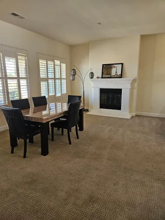 a kitchen with granite countertop a stove a sink a refrigerator and cabinets