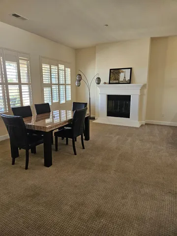 a kitchen with granite countertop a stove a sink a refrigerator and cabinets