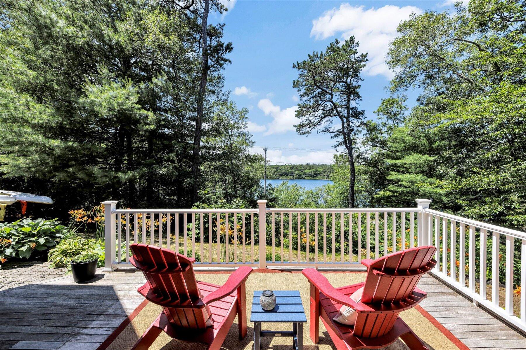 1 Ravens Nest Road Sandwich, MA 02563 - Photo 1 of 46 a view of a chair and table on the deck