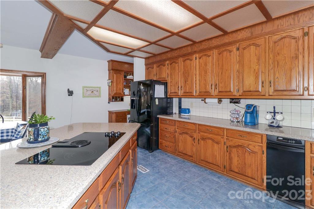 3449 Lee Moore Road Maiden, NC 28650 - Photo 19 of 48 a kitchen with stainless steel appliances granite countertop a sink a stove and a wooden cabinets